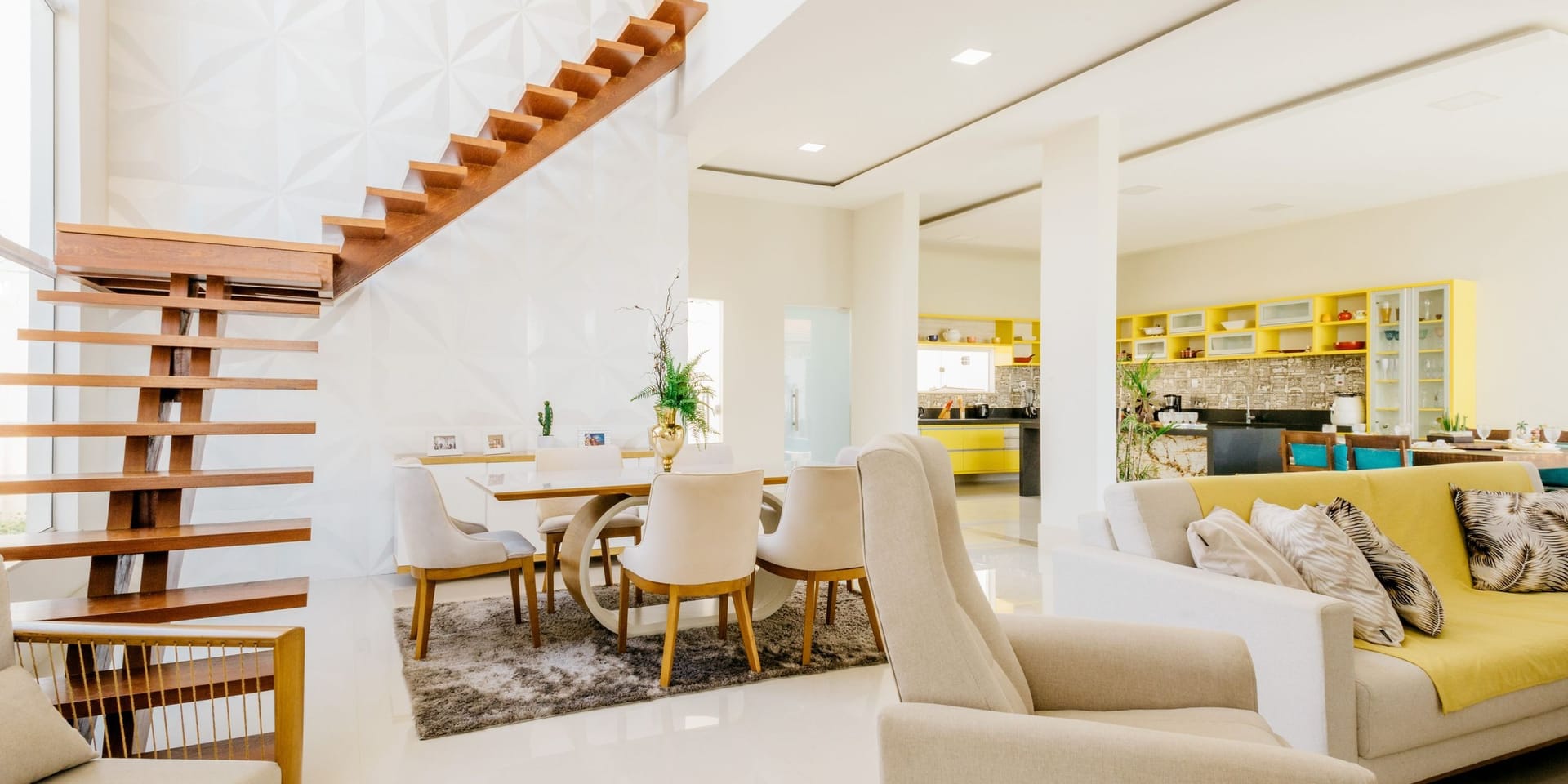 A bright, spotless open-plan living and dining room in soft cream and pale wood